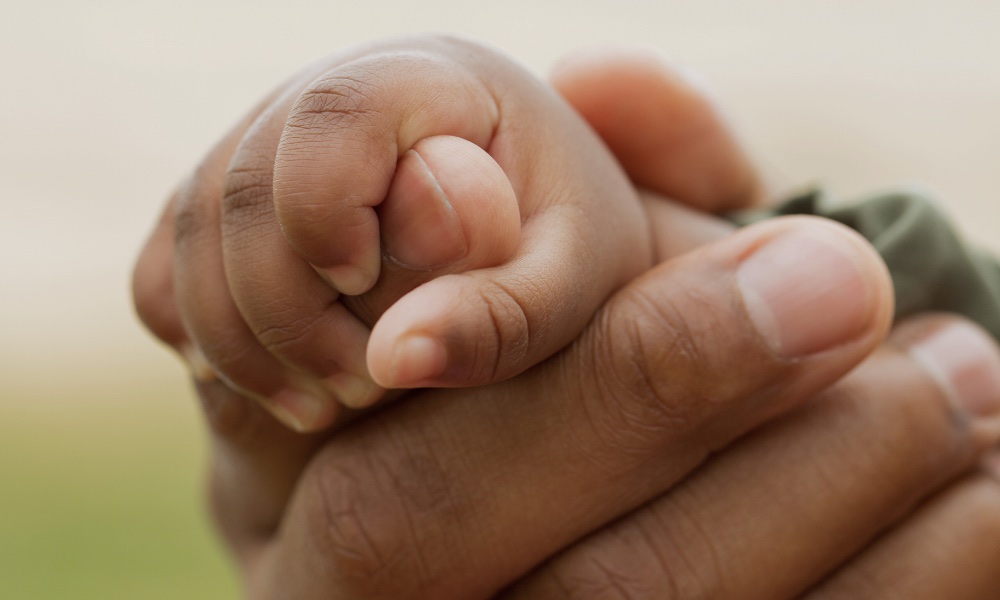 extravagant tenderness holding child's hand love